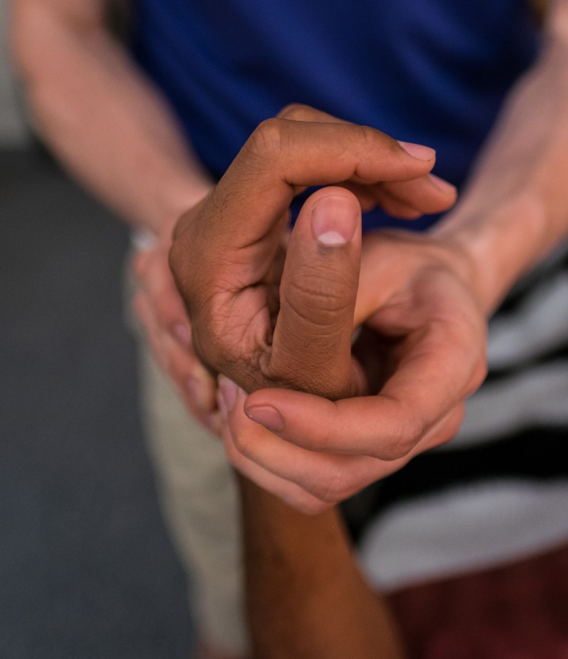 Photo: Manual therapy - practitioner hands on client hand